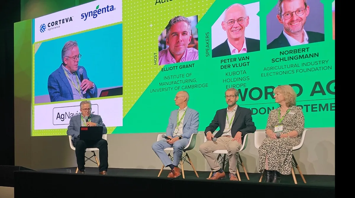 Panellists seated on stage beneath a screen showing the speakers' names and portraits: Elliott Grant, Institute for Manufacturing, University of Cambridge; Peter van der Vlugt, Kubota Holdings Europe; Norbert Schlingmann, Agricultural Industry Electronics Foundation.