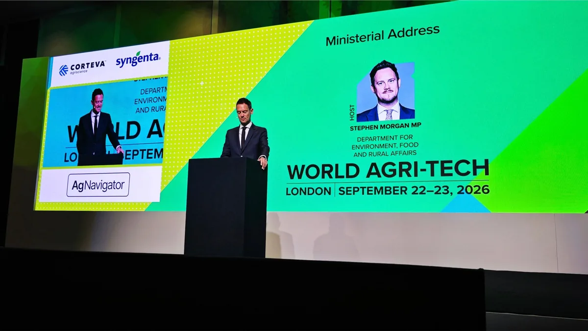 Stephen Morgan MP speaking from a lectern on the summit stage, with a large screen behind him reading Ministerial Address, Stephen Morgan MP, Department for Environment, Food and Rural Affairs.